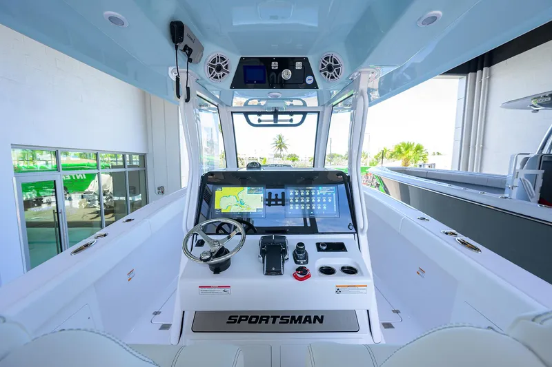 Slide: The Image of 2026 Sportsman Heritage 321 Center Console boat interior with advanced navigation system and steering wheel. - 16