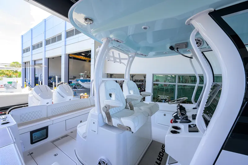 Slide: The Image of 2026 Sportsman Heritage 321 Center Console boat interior with modern helm and seating. - 17