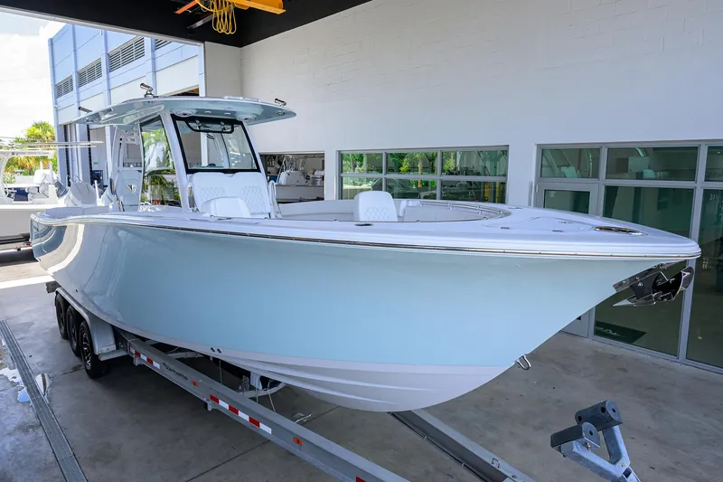 Slide: The Image of 2026 Sportsman Heritage 321 Center Console boat on trailer in showroom. - 2