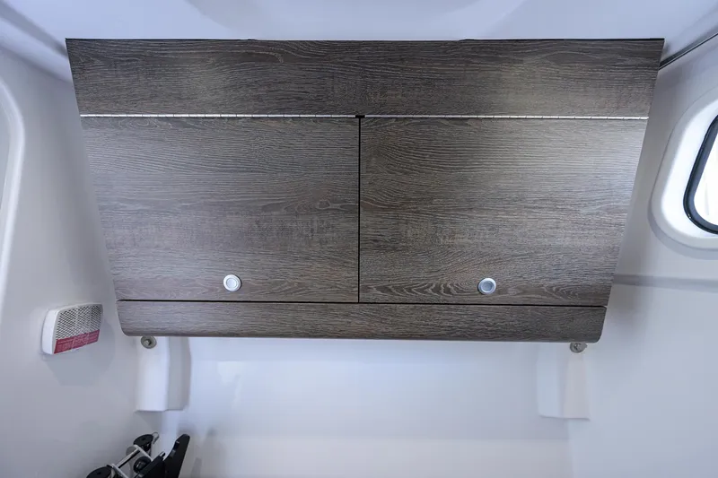 Slide: The Image of Wooden cabinet inside 2026 Sportsman Heritage 321 Center Console boat. - 20