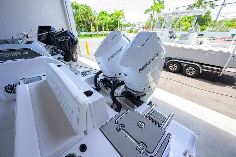 Slide: The Image of 2026 Sportsman Heritage 321 Center Console with dual Mercury outboard engines, docked near trailer. - 23