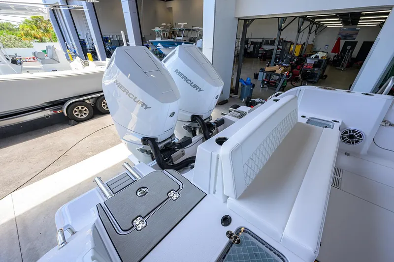 Slide: The Image of 2026 Sportsman Heritage 321 Center Console with dual Mercury engines in a showroom setting. - 24