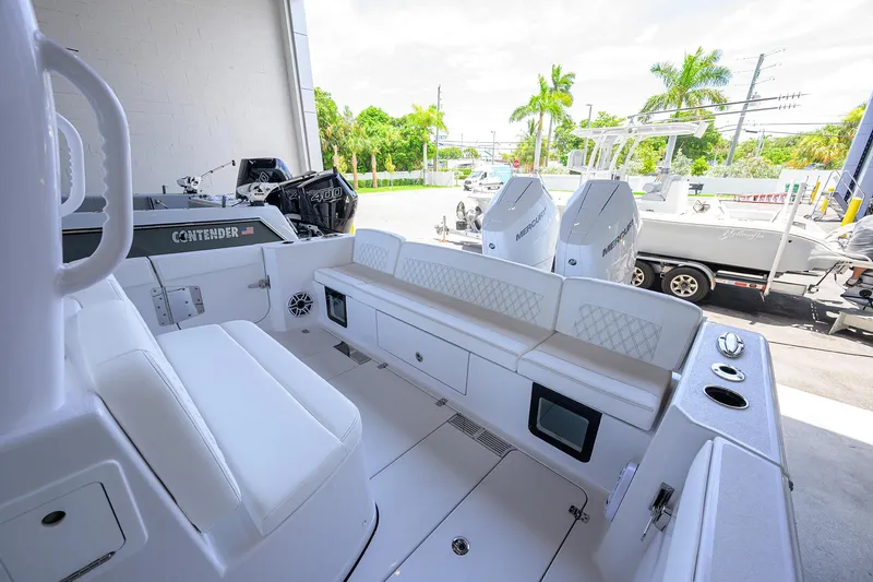Slide: The Image of 2026 Sportsman Heritage 321 Center Console boat interior with seating and dual Mercury engines. - 26