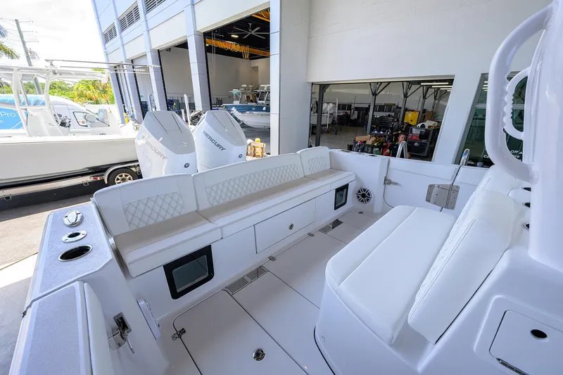 Slide: The Image of 2026 Sportsman Heritage 321 Center Console boat interior with seating and Mercury engines. - 27