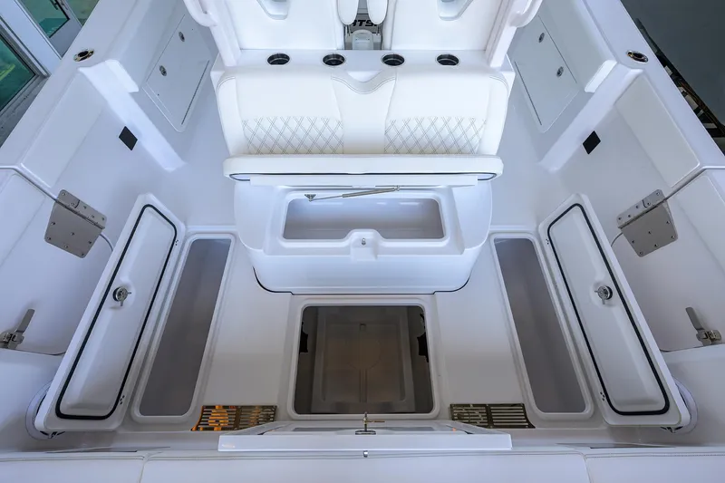 Slide: The Image of 2026 Sportsman Heritage 321 Center Console interior with white seating and storage compartments. - 29