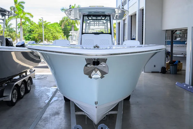 Slide: The Image of 2026 Sportsman Heritage 321 Center Console boat in showroom, front view. - 3