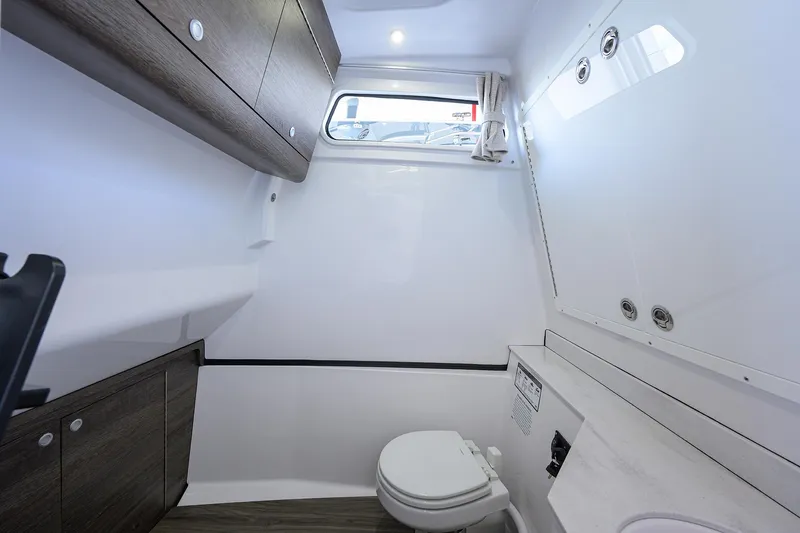 Slide: The Image of 2026 Sportsman Heritage 321 Center Console boat interior with modern bathroom amenities. - 37