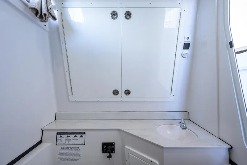 Slide: The Image of 2026 Sportsman Heritage 321 Center Console interior with sink and storage cabinet. - 38