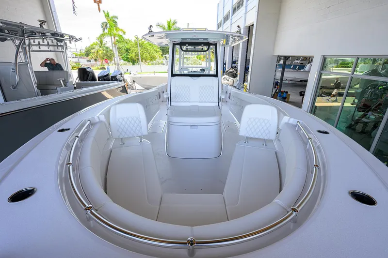 Slide: The Image of 2026 Sportsman Heritage 321 Center Console boat interior with white seating and modern design. - 4