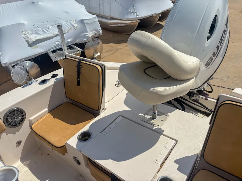 Slide: The Image of 2024 Carolina Skiff 22 Ultra Elite boat interior with seating and Suzuki outboard motor. - 12