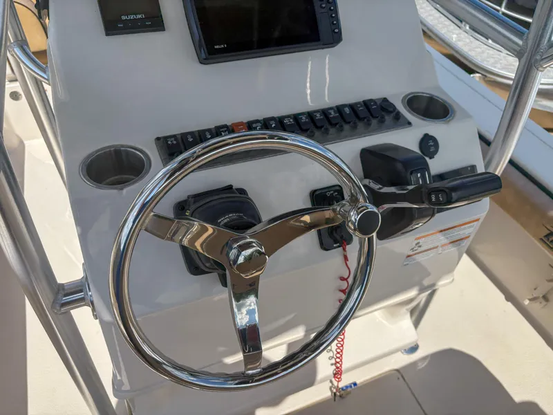 Slide: The Image of 2024 Carolina Skiff 22 Ultra Elite helm with steering wheel and controls. - 13