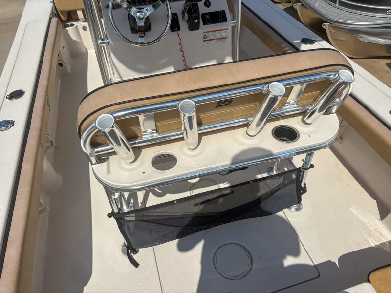 Slide: The Image of 2024 Carolina Skiff 22 Ultra Elite boat interior with rod holders and steering console. - 16