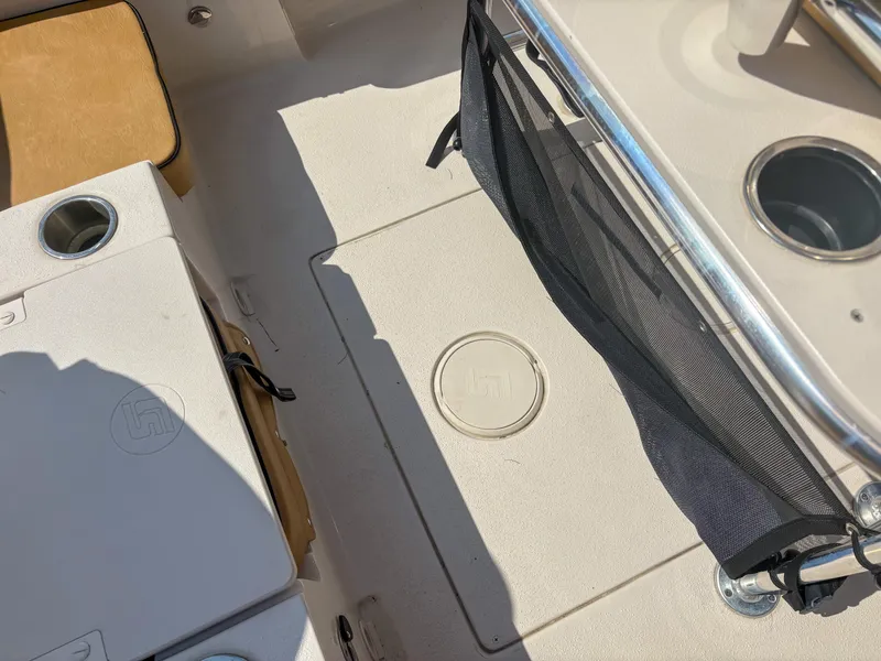 Slide: The Image of 2024 Carolina Skiff 22 Ultra Elite boat interior with seating and storage compartments. - 17