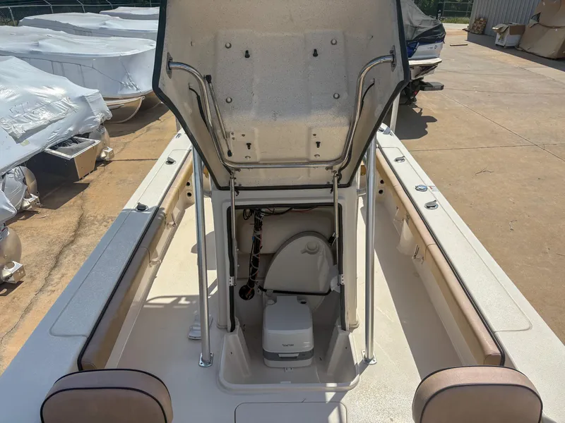 Slide: The Image of 2024 Carolina Skiff 22 Ultra Elite boat interior with open storage compartment. - 18