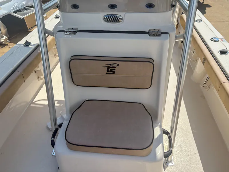 Slide: The Image of 2024 Carolina Skiff 22 Ultra Elite boat seat with logo, featuring beige cushions. - 8