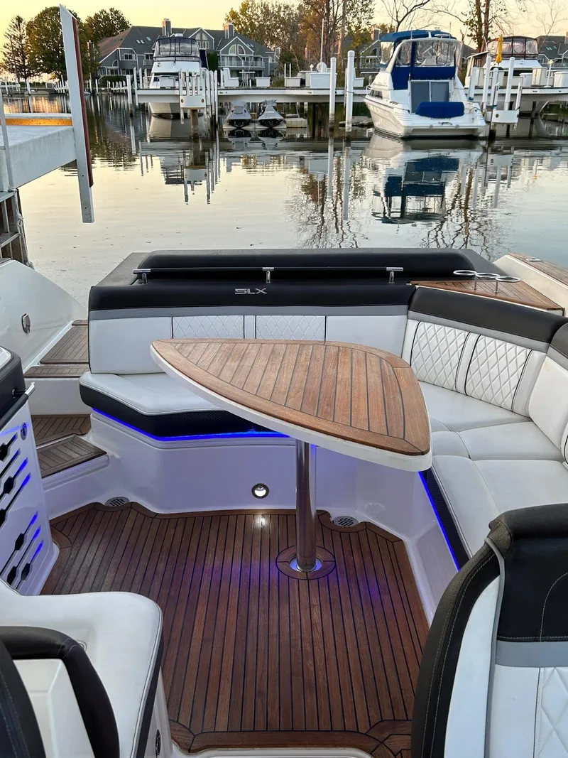 Slide: The Image of Luxurious 2016 Sea Ray 310 SLX boat interior with elegant seating and wooden table. - 4