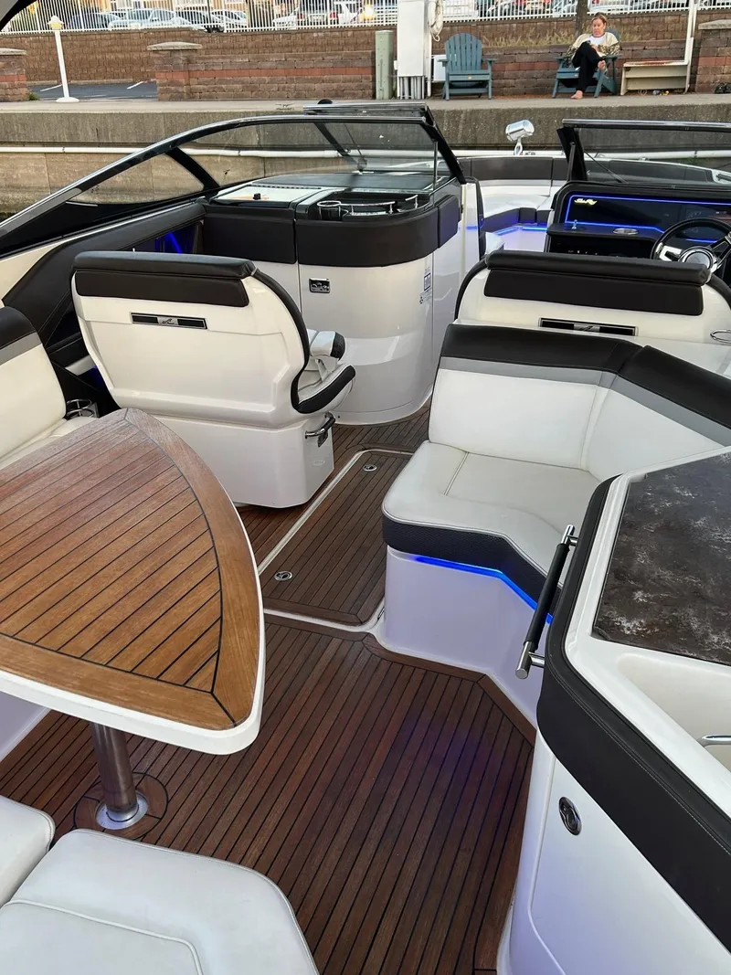 Slide: The Image of Luxurious 2016 Sea Ray 310 SLX boat interior with elegant seating and wooden table. - 5