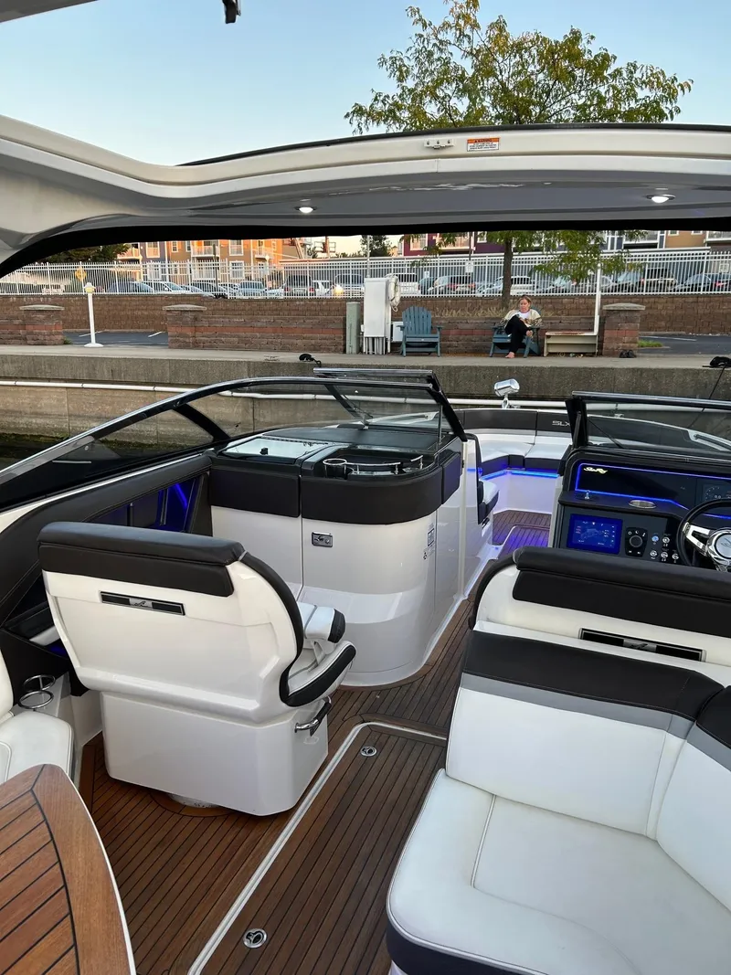 Slide: The Image of Interior of 2016 Sea Ray 310 SLX boat with modern seating and controls. - 8