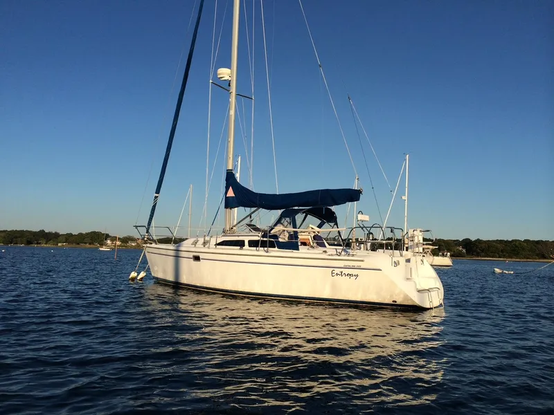 The Image of Sailboat Catalina 320, 1999 model, anchored on calm water under clear blue sky. - 0