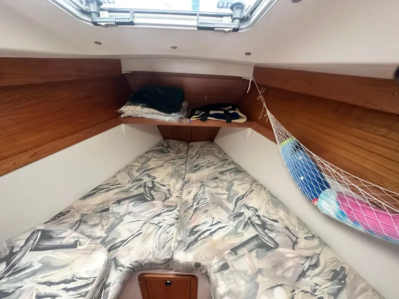Slide: The Image of Interior cabin of a 1999 Catalina 320 sailboat with twin beds and storage. - 22