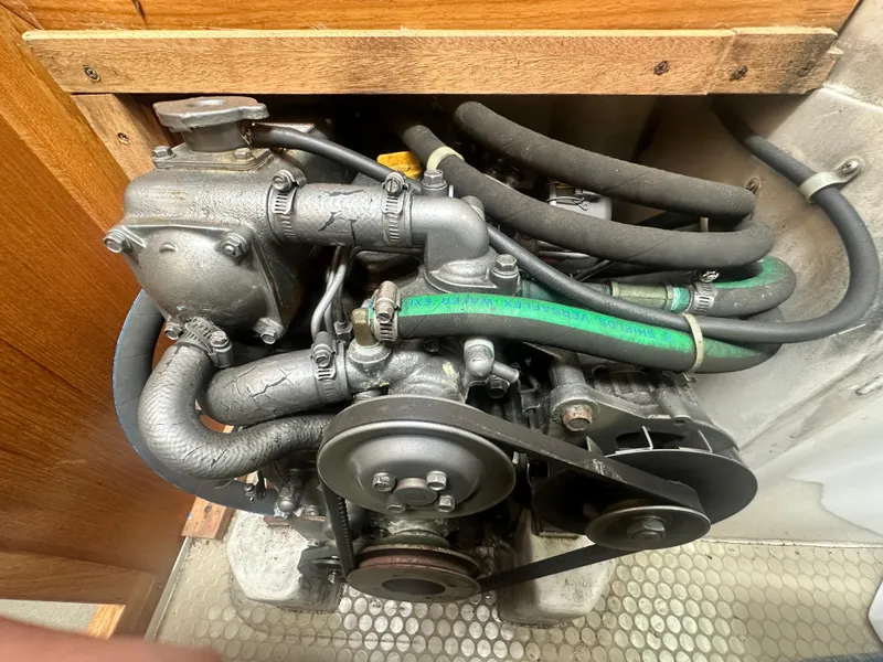 Slide: The Image of Engine compartment of a 1999 Catalina 320 sailboat, showing hoses and mechanical components. - 29