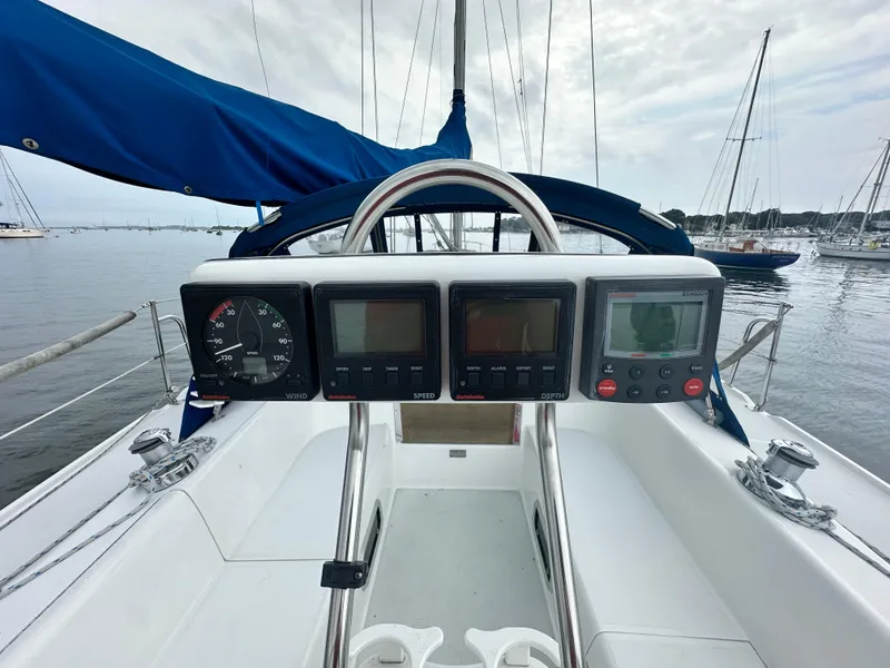 Slide: The Image of Cockpit view of 1999 Catalina 320 sailboat with navigation instruments and blue sail cover. - 6