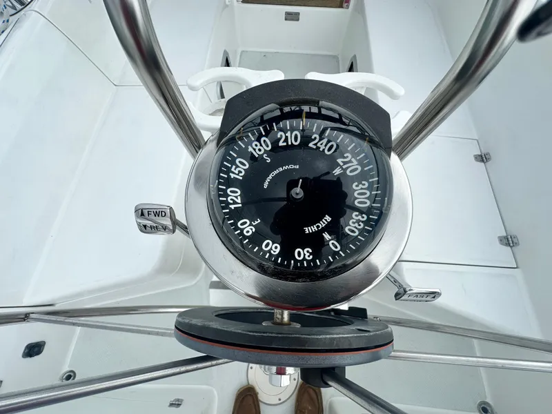 Slide: The Image of Compass on a 1999 Catalina 320 sailboat cockpit, showing navigation controls. - 7