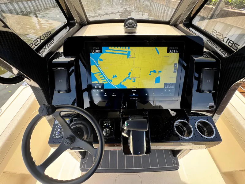 Slide: The Image of 2026 Scout 281 XSS boat dashboard with GPS navigation display and steering wheel. - 15