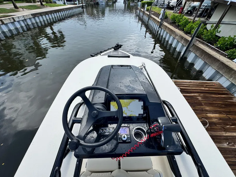 Slide: The Image of Steering console of 2026 Scout 281 XSS boat docked by a canal. - 18
