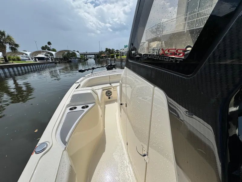 Slide: The Image of 2026 Scout 281 XSS boat docked on a calm waterway under a cloudy sky. - 19