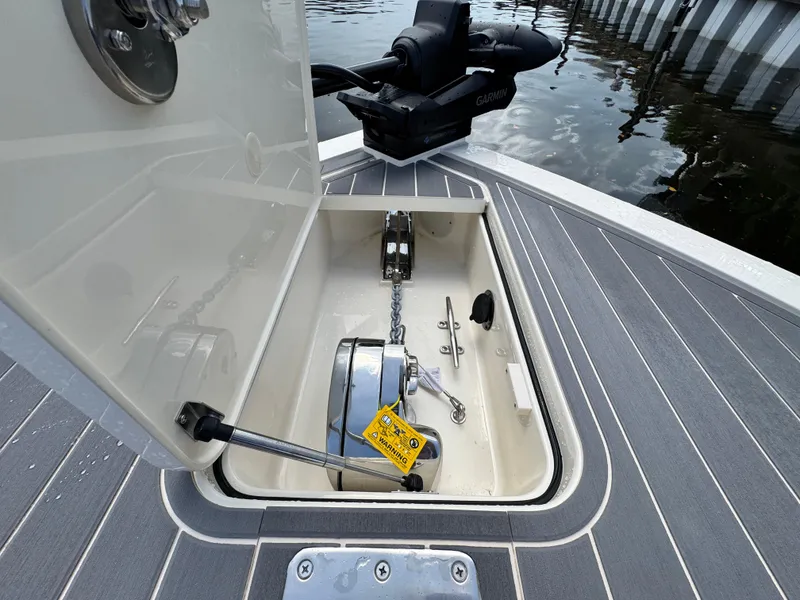 Slide: The Image of Open anchor compartment on 2026 Scout 281 XSS boat with visible equipment. - 24