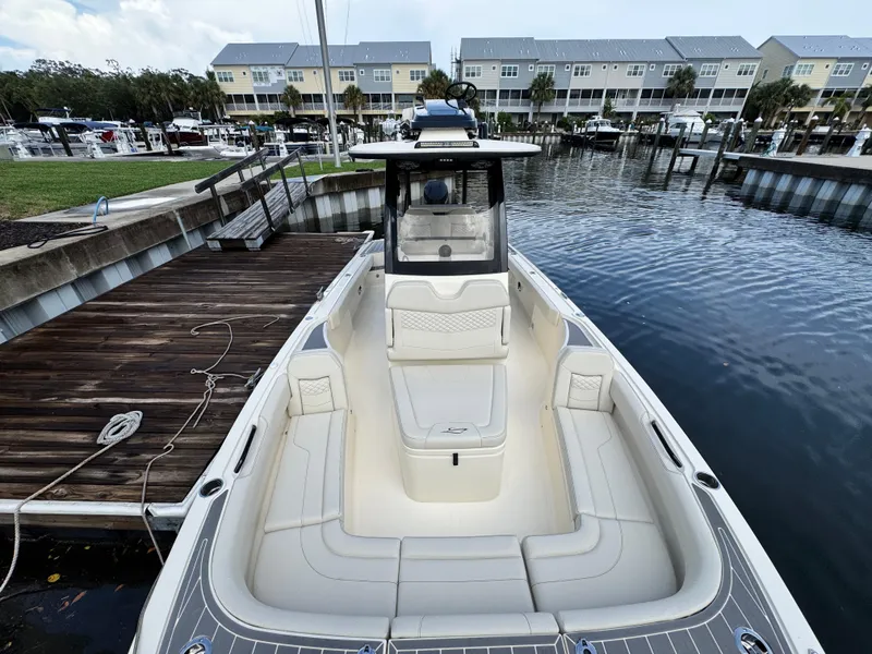 Slide: The Image of 2026 Scout 281 XSS boat docked at marina, featuring spacious seating and modern design. - 26