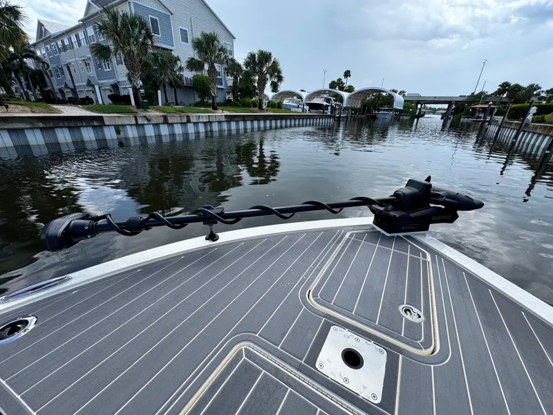 Slide: The Image of Bow of 2026 Scout 281 XSS boat with Garmin equipment, docked in a scenic canal. - 28