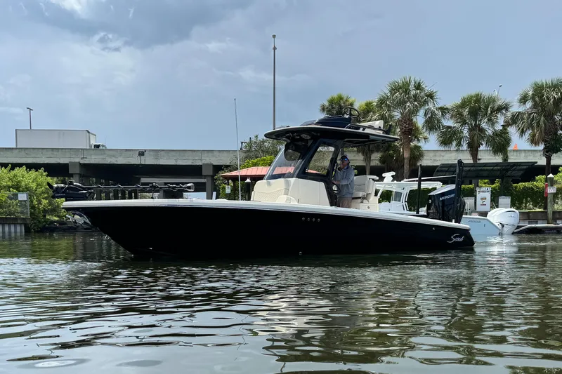 Slide: The Image of 2026 Scout 281 XSS boat on water, with palm trees and bridge in background. - 5
