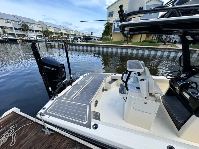 Slide: The Image of 2026 Scout 281 XSS boat docked, featuring Mercury engine and sleek design. - 7