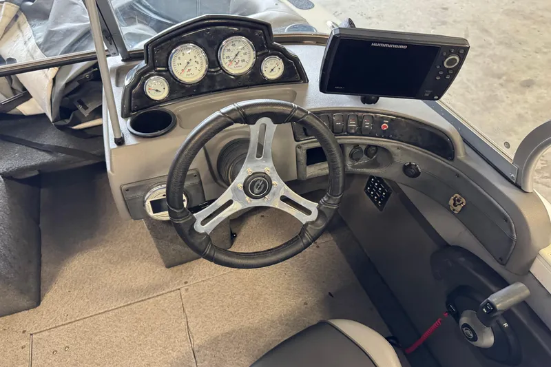 Slide: The Image of 2017 Crestliner 1850 Sportfish Outboard dashboard with steering wheel and navigation system. - 10