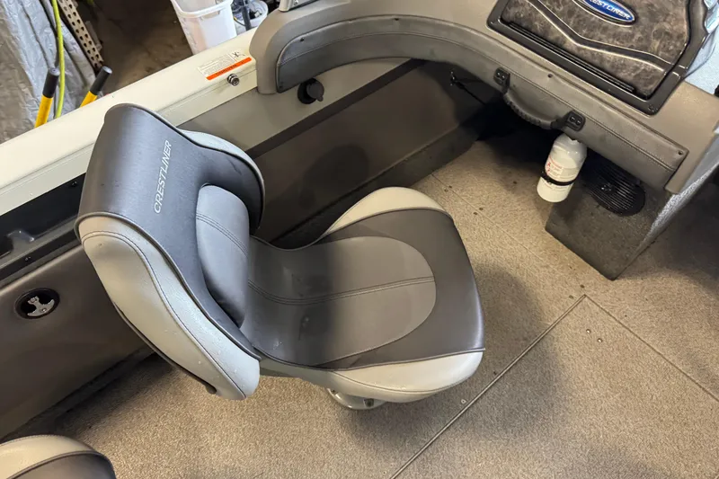 Slide: The Image of 2017 Crestliner 1850 Sportfish Outboard boat seat, gray and black design, interior view. - 11
