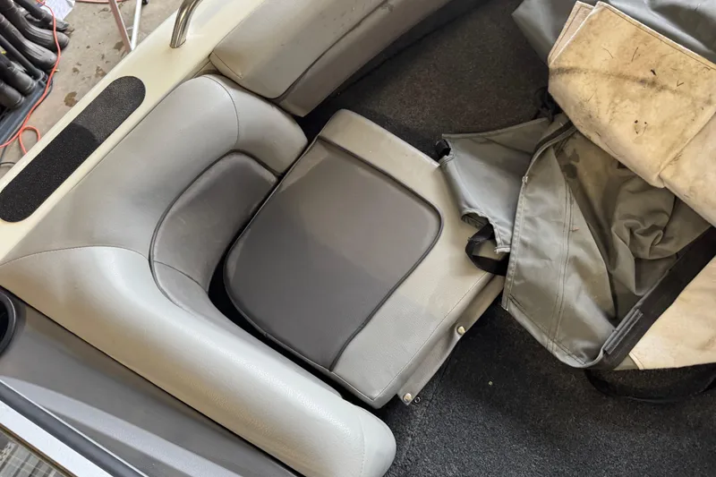 Slide: The Image of 2017 Crestliner 1850 Sportfish Outboard interior seating with gray upholstery and storage cover. - 14