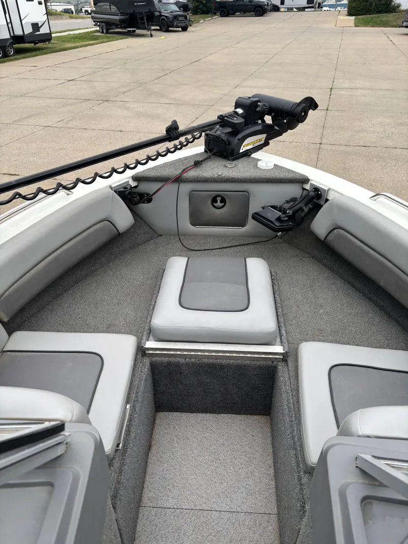 Slide: The Image of 2017 Crestliner 1850 Sportfish Outboard boat interior with gray seating and carpeted flooring. - 6