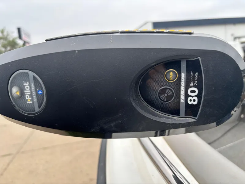 Slide: The Image of 2017 Crestliner 1850 Sportfish Outboard interior compartment with carpeted edges and drainage holes. - 7