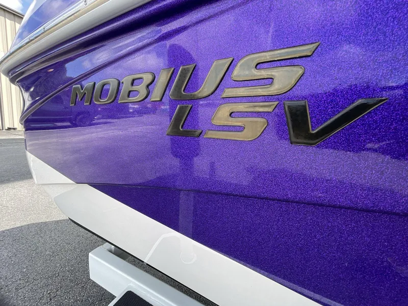 Slide: The Image of 2015 Moomba Mobius LSV boat with purple metallic finish and bold lettering. - 10