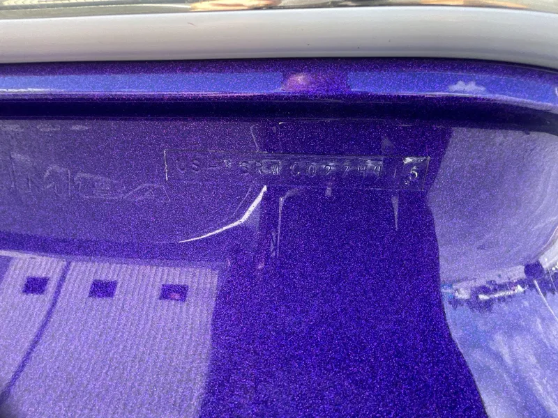 Slide: The Image of 2015 Moomba Mobius LSV boat hull identification number on purple surface. - 11