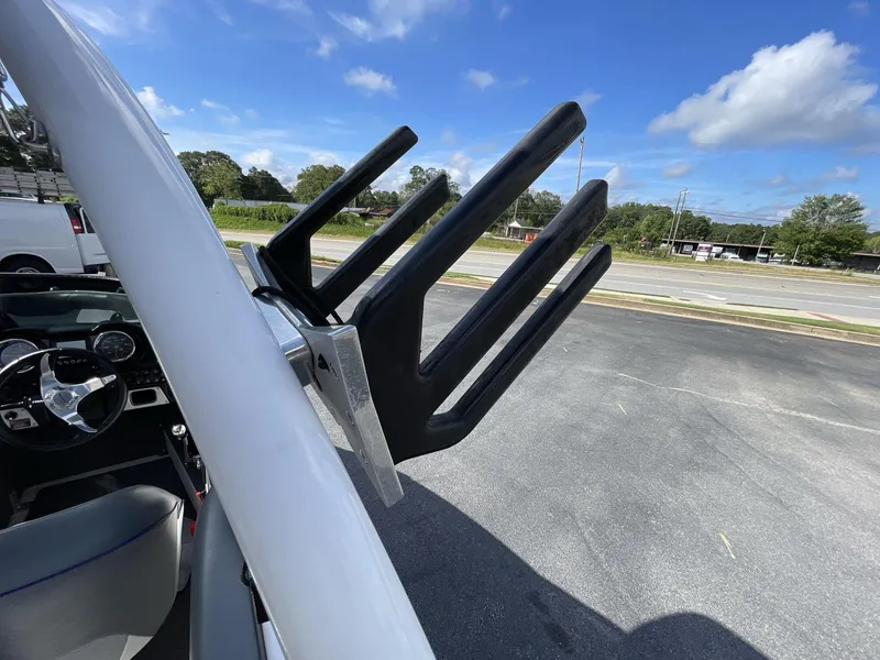 Slide: The Image of 2015 Moomba Mobius LSV boat with wakeboard rack under clear blue sky. - 16