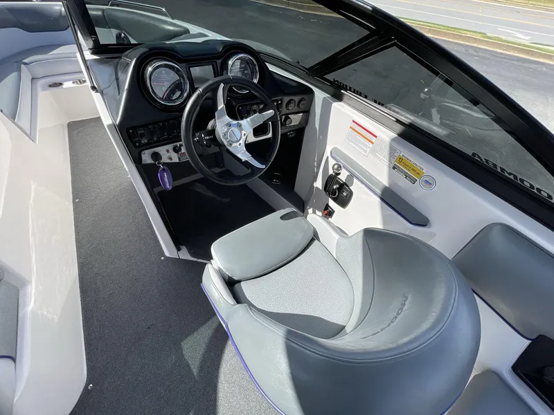 Slide: The Image of 2015 Moomba Mobius LSV boat interior with steering wheel and dashboard controls. - 25