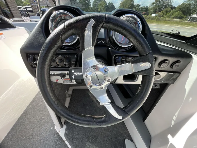 Slide: The Image of Steering wheel and dashboard of a 2015 Moomba Mobius LSV boat. - 27