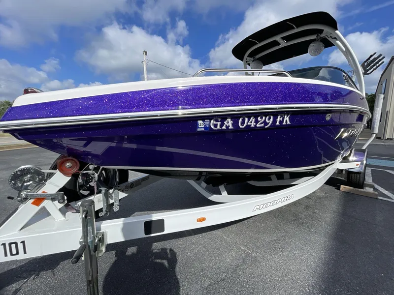 Slide: The Image of 2015 Moomba Mobius LSV boat with sparkling purple finish on a trailer. - 3