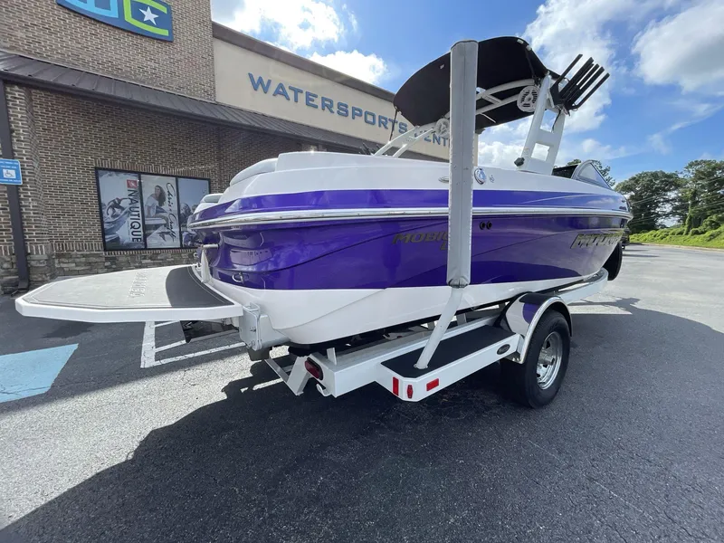 Slide: The Image of 2015 Moomba Mobius LSV boat on trailer outside watersports center. - 7