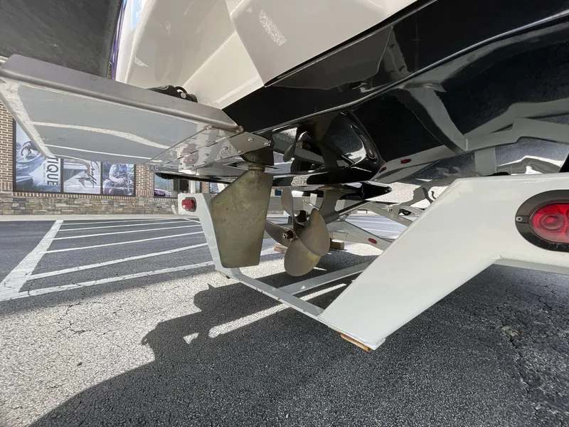 Slide: The Image of 2015 Moomba Mobius LSV boat propeller and rudder detail in parking lot. - 8