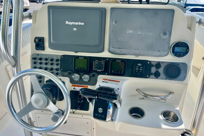 Slide: The Image of 2006 Hydra-Sports Vector 2900 CC boat dashboard with Raymarine electronics and steering wheel. - 10