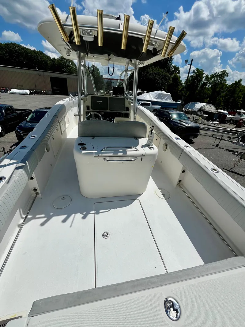 Slide: The Image of 2006 Hydra-Sports Vector 2900 CC boat interior with helm and rod holders under blue sky. - 12